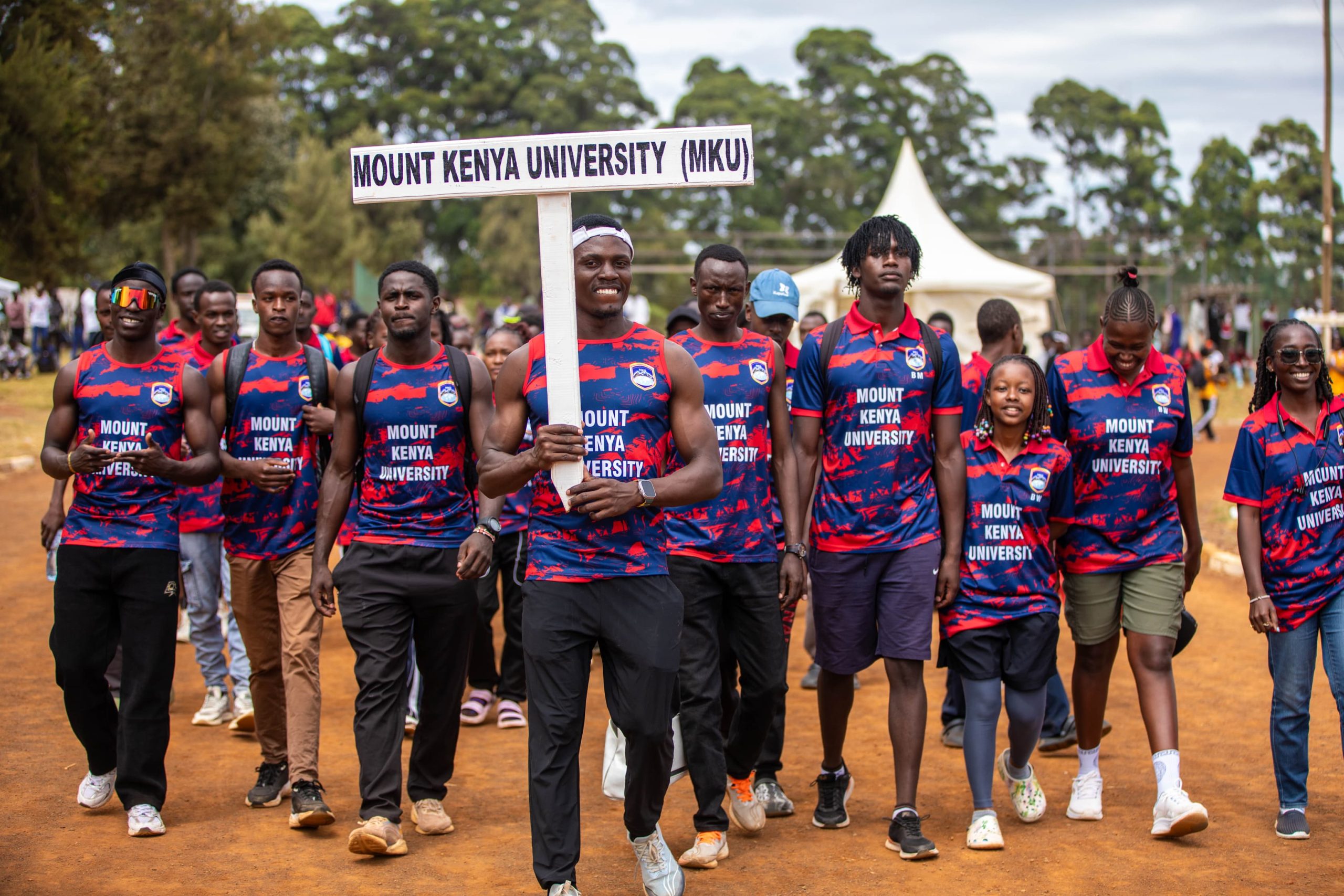 Mount Kenya University students walk through the parade at the opening ceremony of the 10th KUSF national games