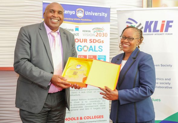 Mount Kenya University Chairman and Founder Simon Gicharu presents a token of appreciation to Dr. Monica Wanjiru Muiru, Vice Chairperson of the Ethics and Anti-Corruption Commission (EACC), during a visit by the EACC delegation to MKU.