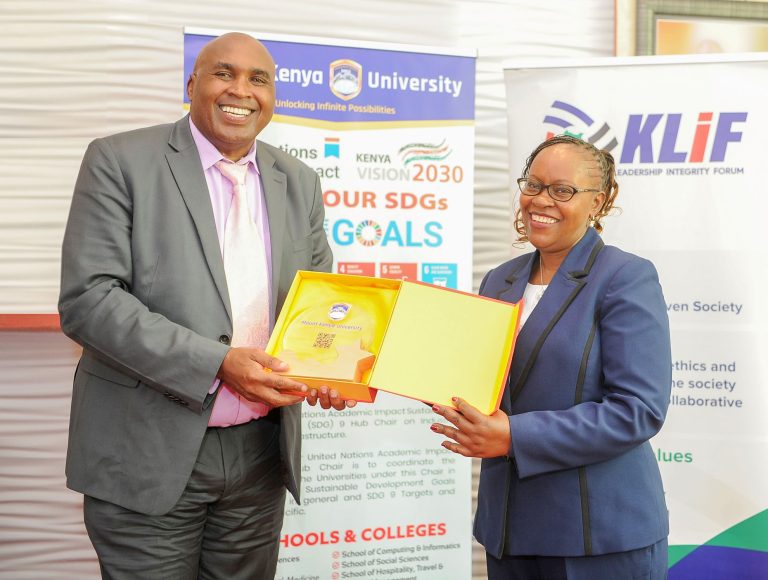 Mount Kenya University Chairman and Founder Simon Gicharu presents a token of appreciation to Dr. Monica Wanjiru Muiru, Vice Chairperson of the Ethics and Anti-Corruption Commission (EACC), during a visit by the EACC delegation to MKU.